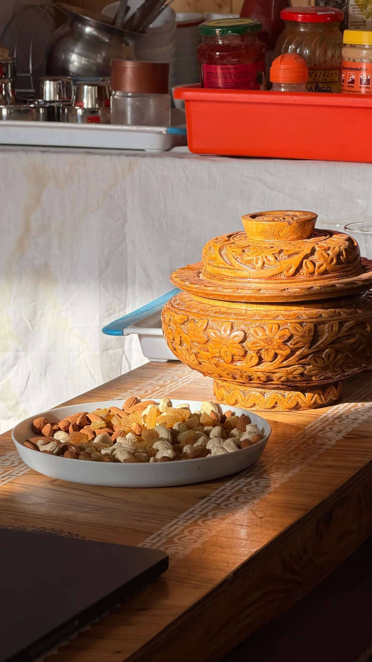 Dried fruit and a carved wooden bowl on the welcome table